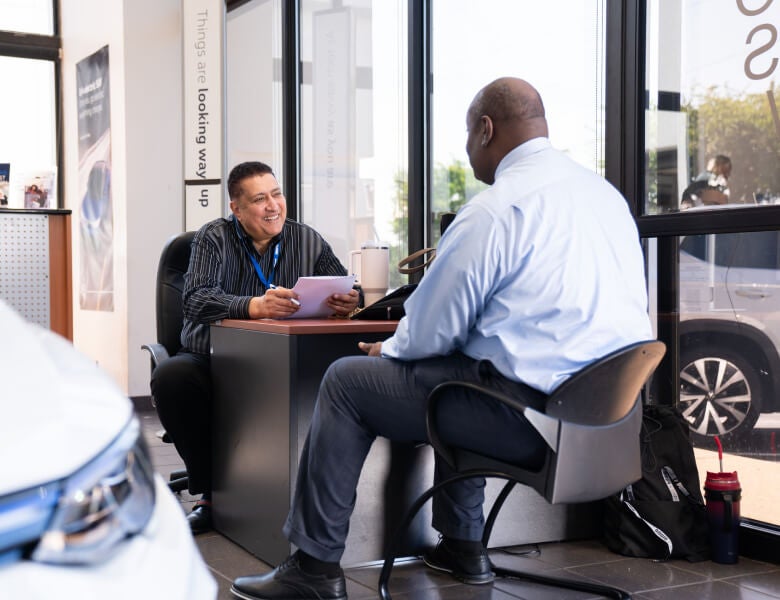 Dealership Rep. going over paperwork